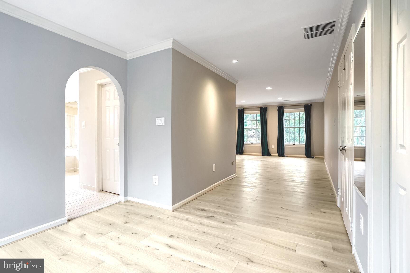 1222 Ranleigh Road McLean, VA 22101 - Photo 18 of 49 a view of a hallway with wooden floor and a chandelier