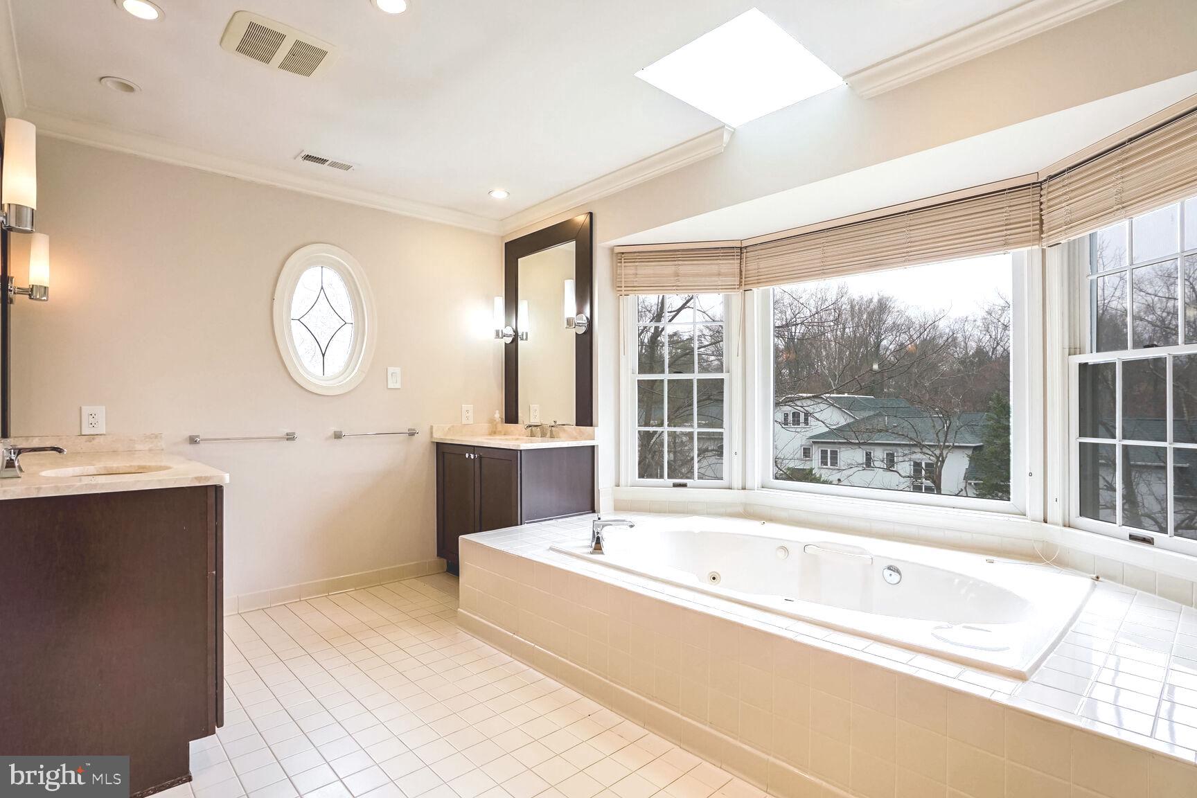 1222 Ranleigh Road McLean, VA 22101 - Photo 27 of 49 a spacious bathroom with a tub double vanity sink and a mirror