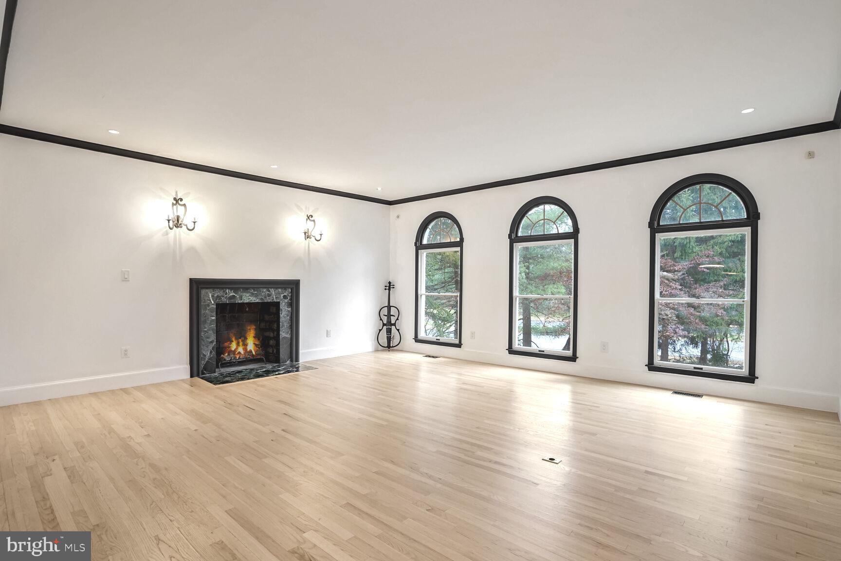 1222 Ranleigh Road McLean, VA 22101 - Photo 6 of 49 an empty room with windows fireplace and wooden floor