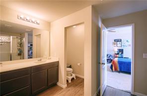 12005 Riparian Road Manor, TX 78653 - Photo 3 of 6 a en suite bathroom with a double vanity sink and a mirror