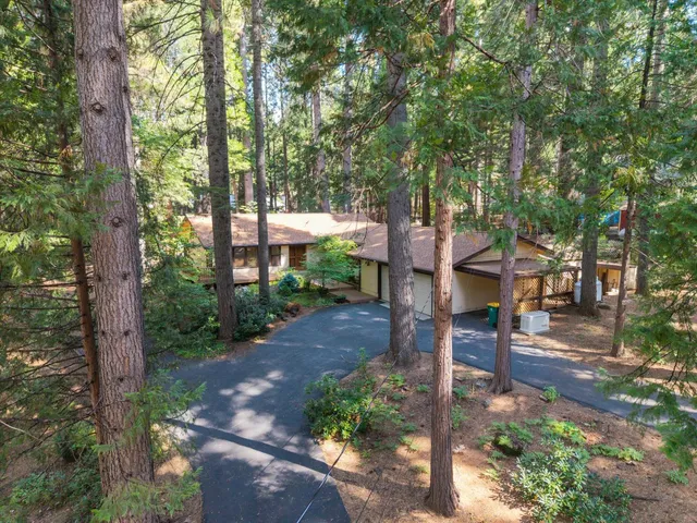 a view of a patio with a table and chairs under an umbrella