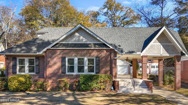 a front view of a house with garden
