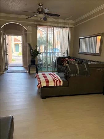 a living room with furniture and a floor to ceiling window