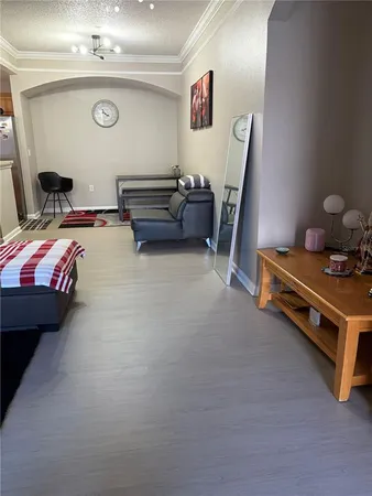 a bedroom with furniture and a mirror