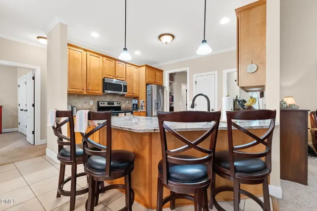 a dining room with furniture and a floor to ceiling window