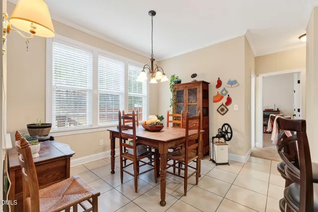 a view of a dining room with furniture and a chandelier
