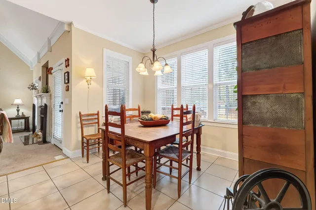a view of a a dining room with furniture window and wooden floor