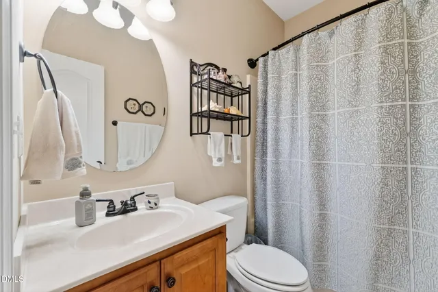 a bathroom with a sink vanity mirror and toilet