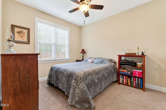 a bedroom with bed and window