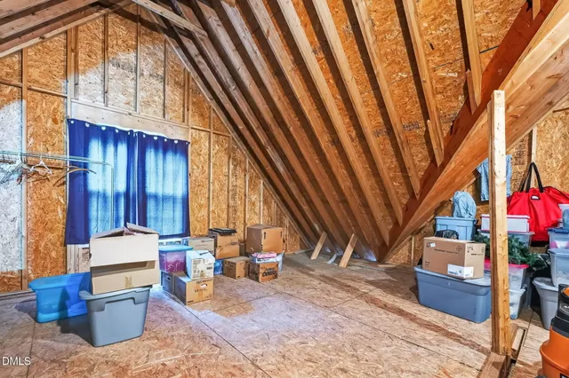 a backyard of a house with wooden floor and outdoor seating