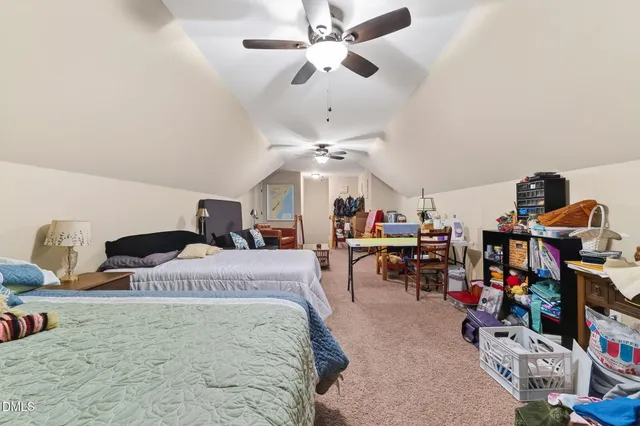 a bedroom with bed and a chandelier