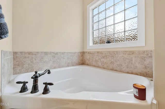 a bath tub sitting in a bathroom next to a window