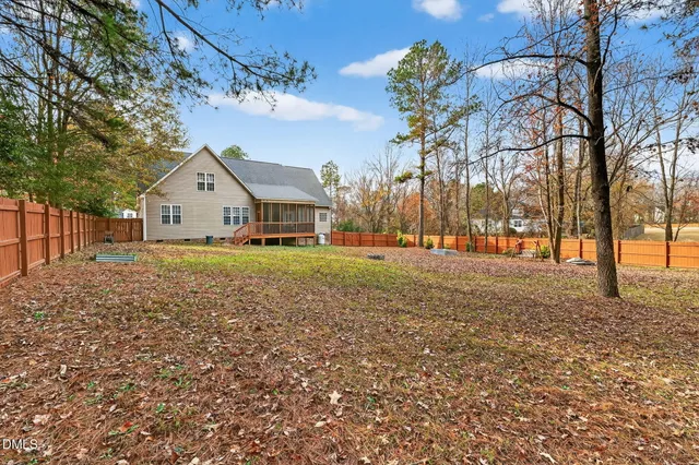 a view of house with backyard of house
