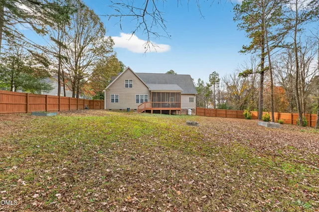 a front view of house with yard and trees around