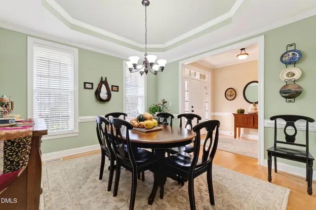 a dining room with furniture a chandelier and window
