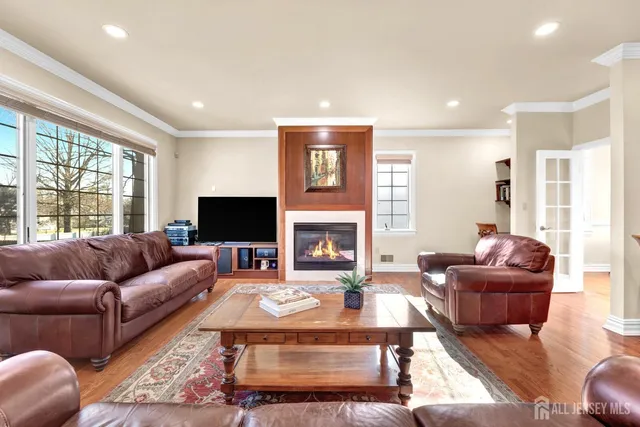 a living room with furniture fireplace and a large window