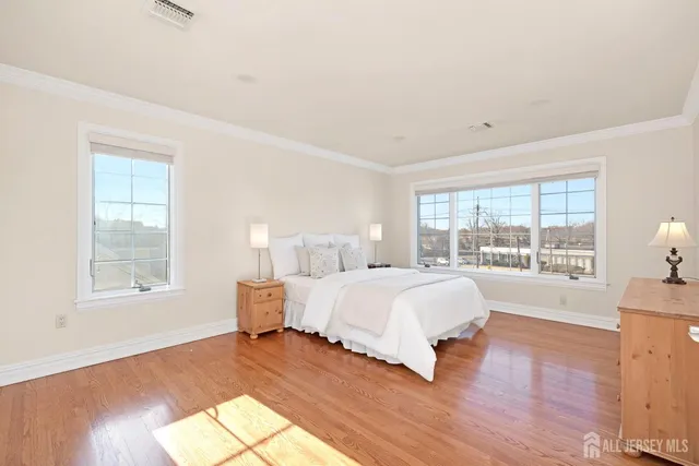a spacious bedroom with a bed and a large window