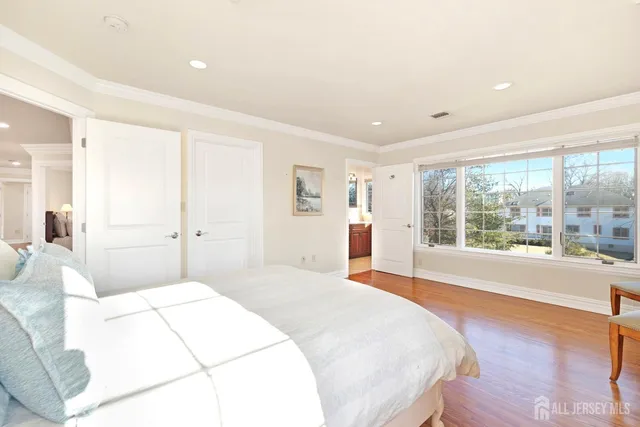 a spacious bedroom with a large bed and a large window