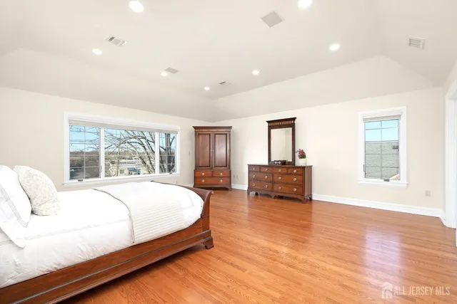 a spacious bedroom with a large bed and a large window