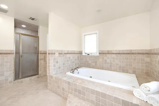 a bathroom with a bathtub and shower