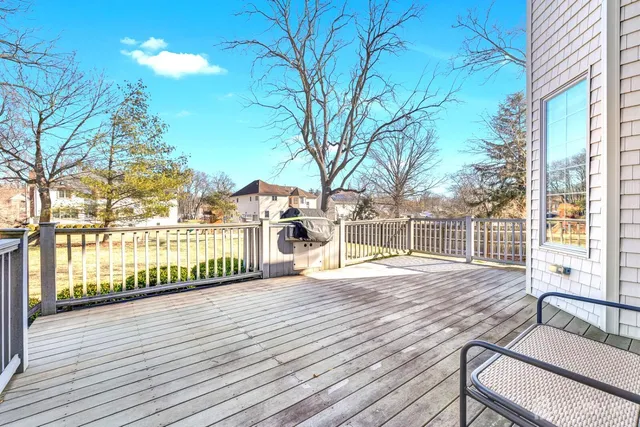 a view of backyard with deck and wooden floor