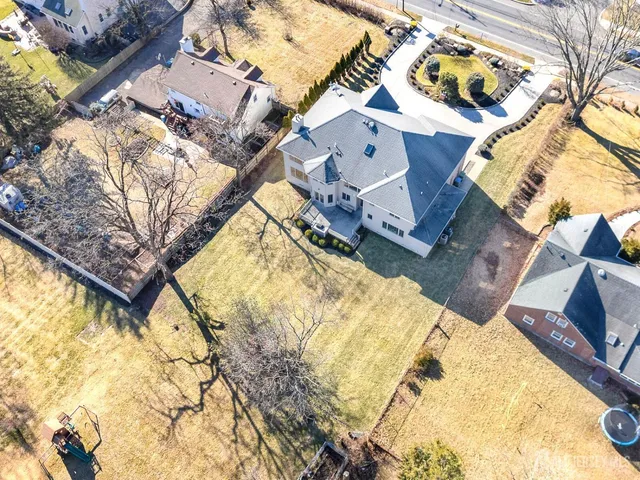 an aerial view of residential houses with outdoor space and swimming pool