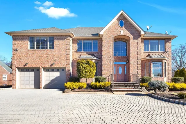 a view of a brick house with many windows