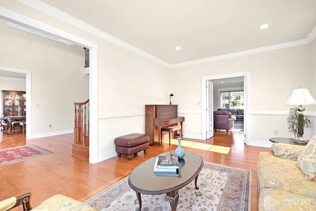 a living room with furniture a rug and a table