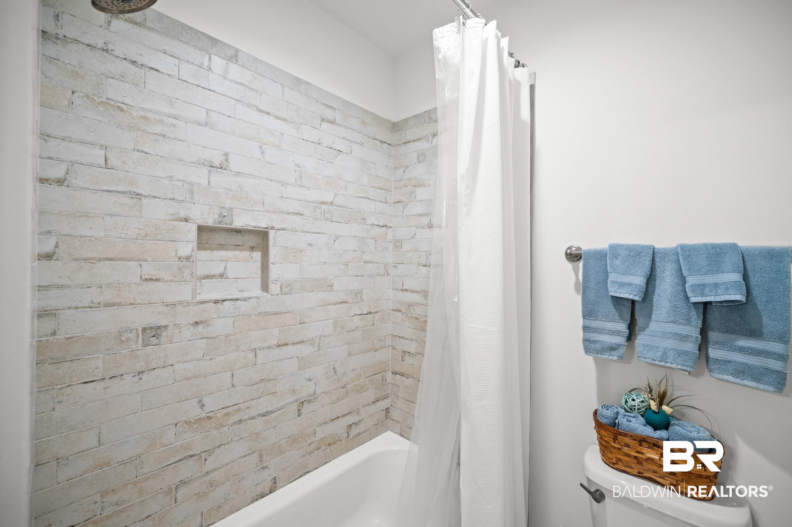 4601 Surrey Lane Orange Beach, AL 36561 - Photo 30 of 43 Bathroom featuring toilet and shower / bathtub combination with curtain