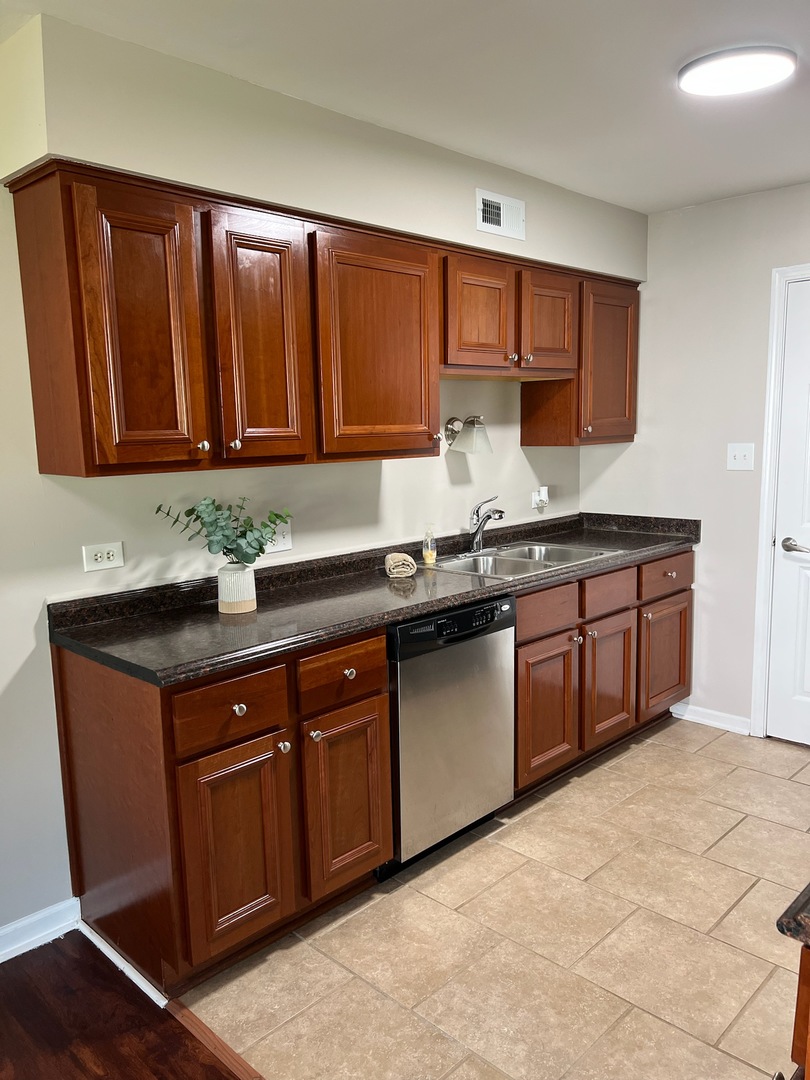 57 Red Barn Road, Unit 1 Matteson, IL 60443 - Photo 6 of 21 a kitchen with stainless steel appliances granite countertop a sink and cabinets
