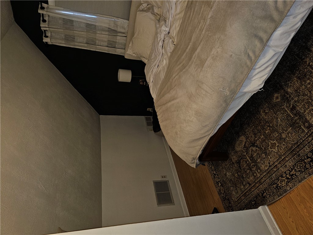 2105 Shroyer Road Dayton, OH 45419 - Photo 21 of 35 This cozy bedroom features hardwood floors and a striking accent wall, creating a comfortable and inviting atmosphere.