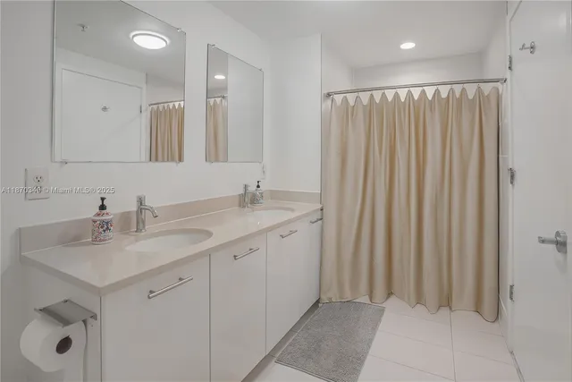 a bathroom with a double vanity sink and a mirror