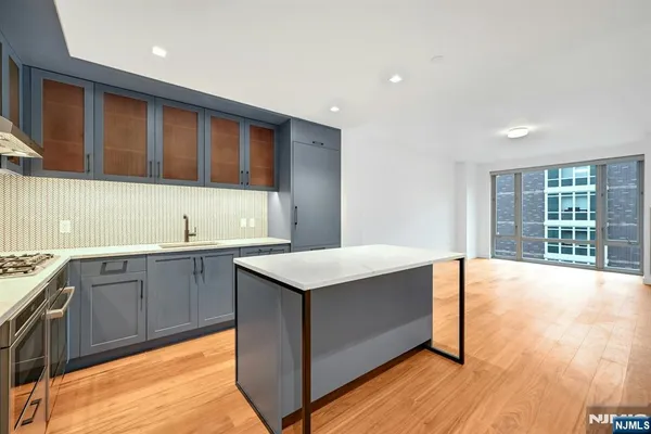 a kitchen with a sink and wooden cabinets