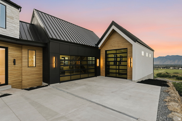 923 North Emery Lane Elk Ridge, UT 84651 - Photo 80 of 101 Modern architectural design featuring vertical wood siding, dark metal accents, and a corrugated metal roof