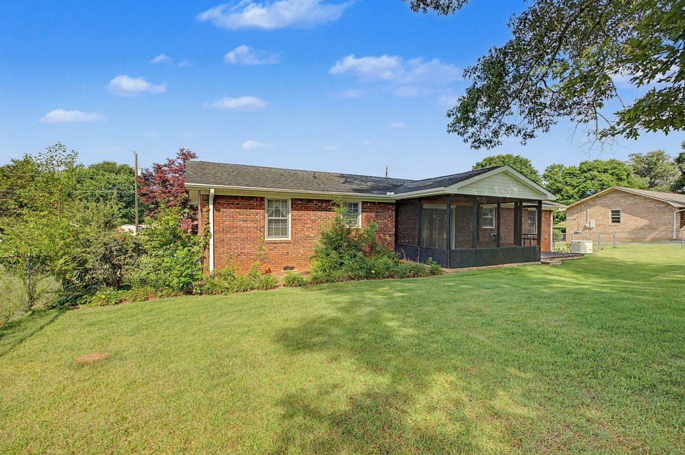 115 Brunson Drive Pickens, SC 29671 - Photo 27 of 29 A screened porch and lush green lawn offer inviting outdoor living space.