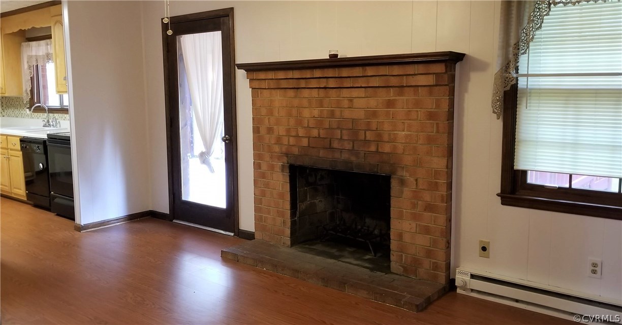 10830 Weybridge Road Chester, VA 23831 - Photo 12 of 33 a view of an empty room with wooden floor and a fireplace