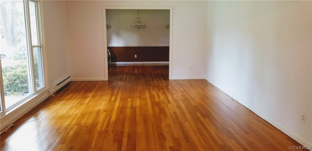 10830 Weybridge Road Chester, VA 23831 - Photo 18 of 33 an empty room with wooden floor and windows