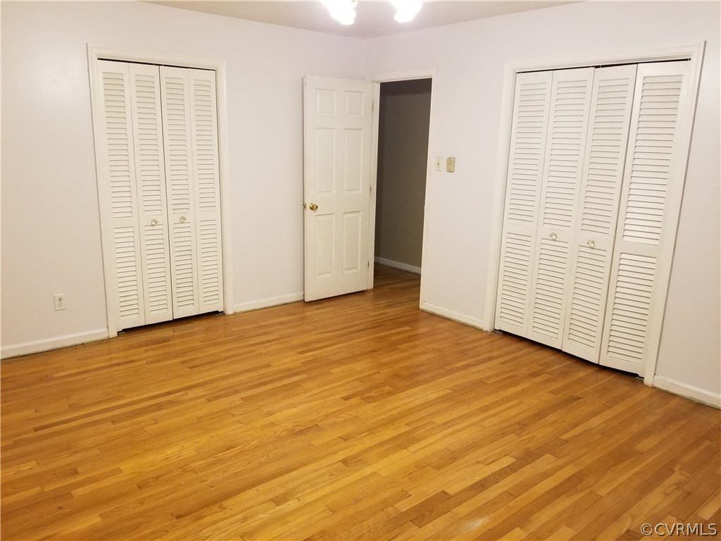 10830 Weybridge Road Chester, VA 23831 - Photo 22 of 33 an empty room with wooden floor and windows