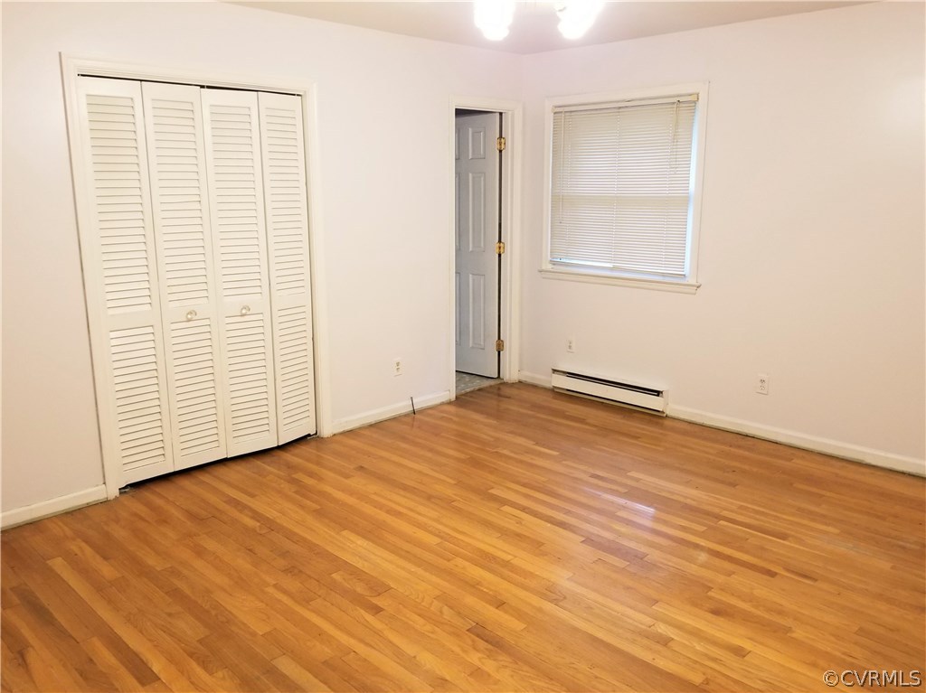 10830 Weybridge Road Chester, VA 23831 - Photo 23 of 33 an empty room with wooden floor and windows