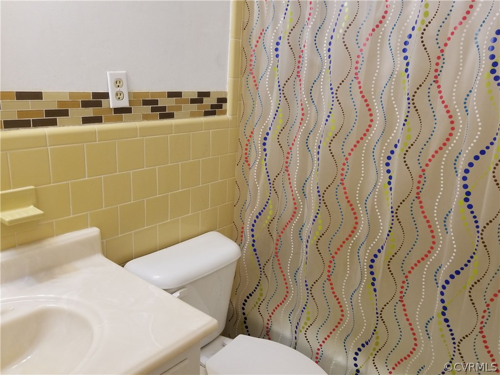 10830 Weybridge Road Chester, VA 23831 - Photo 29 of 33 a bathroom with a toilet and a shower curtain