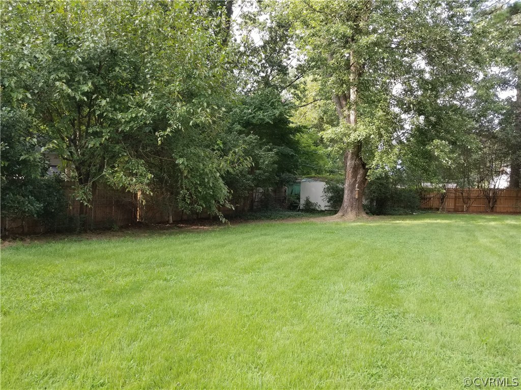 10830 Weybridge Road Chester, VA 23831 - Photo 7 of 33 a view of a field of grass and trees