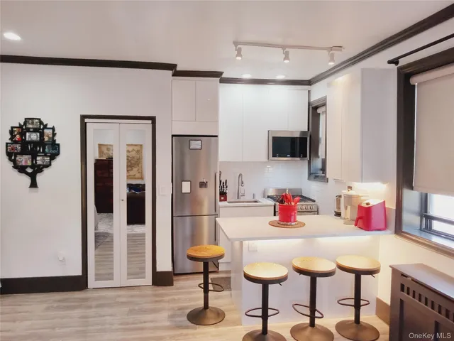 a kitchen with a sink cabinets and stainless steel appliances