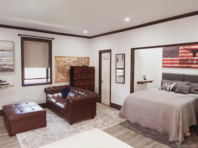 a bedroom with a bed couch and window