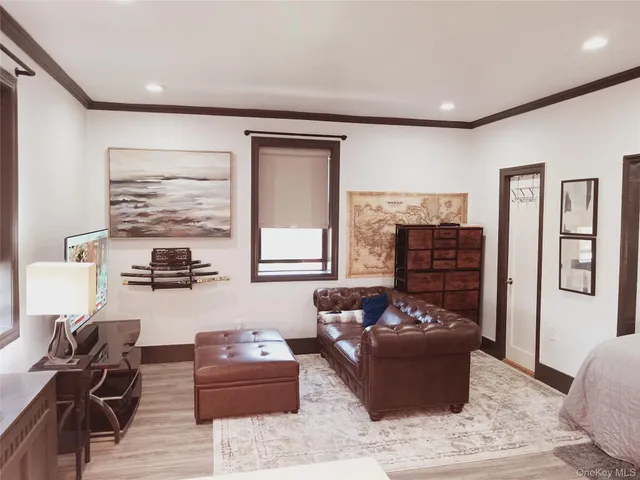 a living room with furniture window and wooden floor