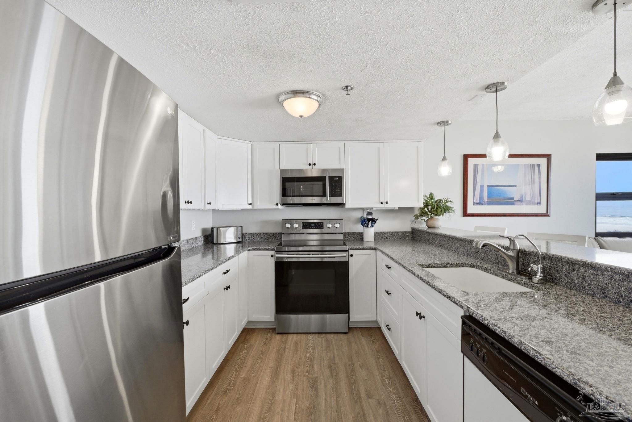 14623 Perdido Key Drive, Unit W201 Perdido Key, FL 32507 - Photo 11 of 57 a kitchen with granite countertop stainless steel appliances a sink cabinets and a window
