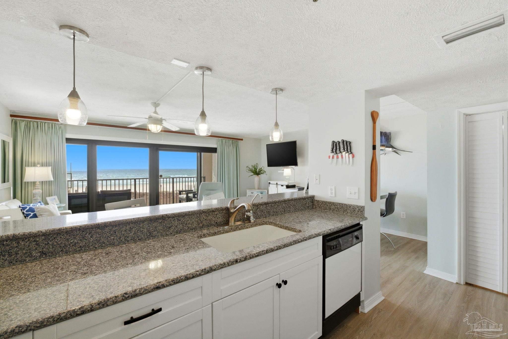 14623 Perdido Key Drive, Unit W201 Perdido Key, FL 32507 - Photo 14 of 57 a kitchen with granite countertop a sink cabinets and wooden floor