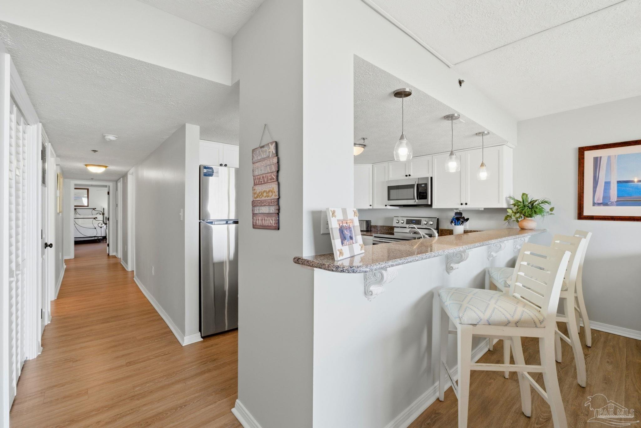 14623 Perdido Key Drive, Unit W201 Perdido Key, FL 32507 - Photo 15 of 57 a view of kitchen with stainless steel appliances refrigerator stove microwave and cabinets