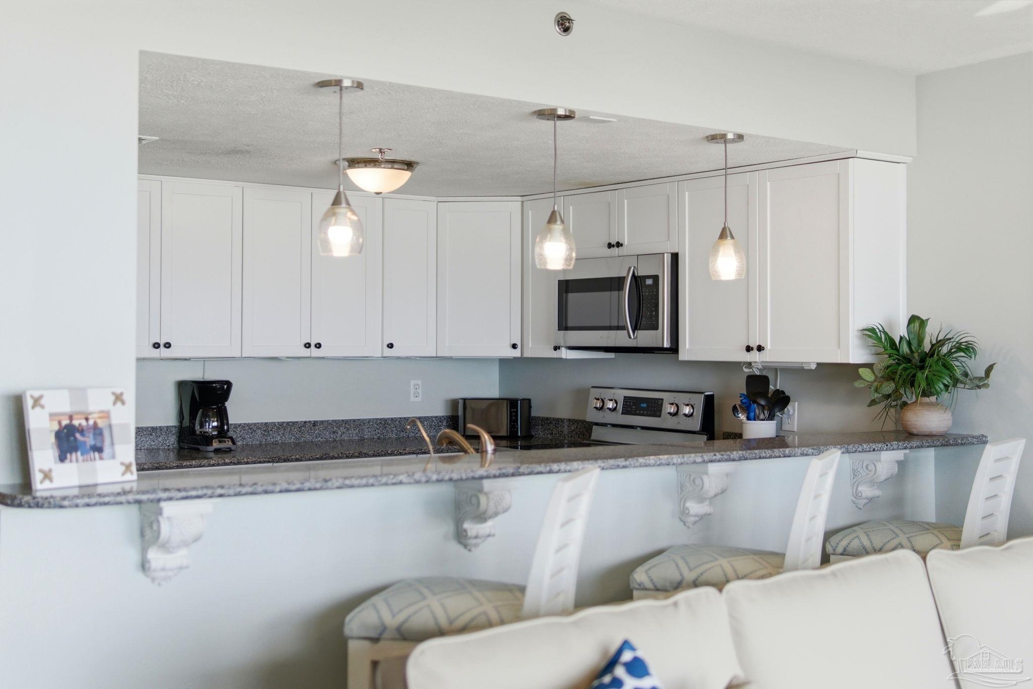 14623 Perdido Key Drive, Unit W201 Perdido Key, FL 32507 - Photo 17 of 57 a kitchen with stainless steel appliances granite countertop a sink a stove and a granite counter tops