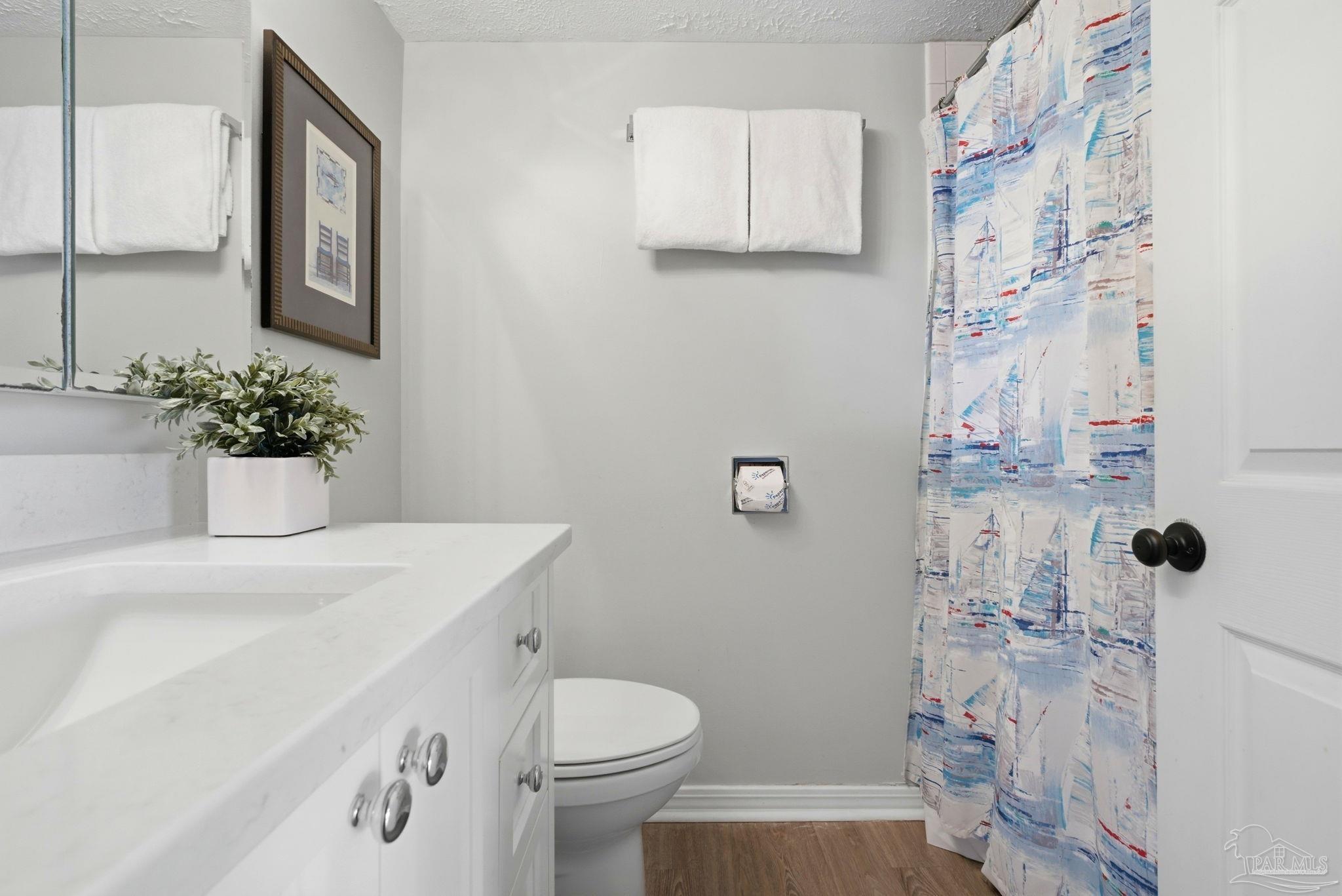 14623 Perdido Key Drive, Unit W201 Perdido Key, FL 32507 - Photo 21 of 57 a bathroom with a sink a toilet and mirror