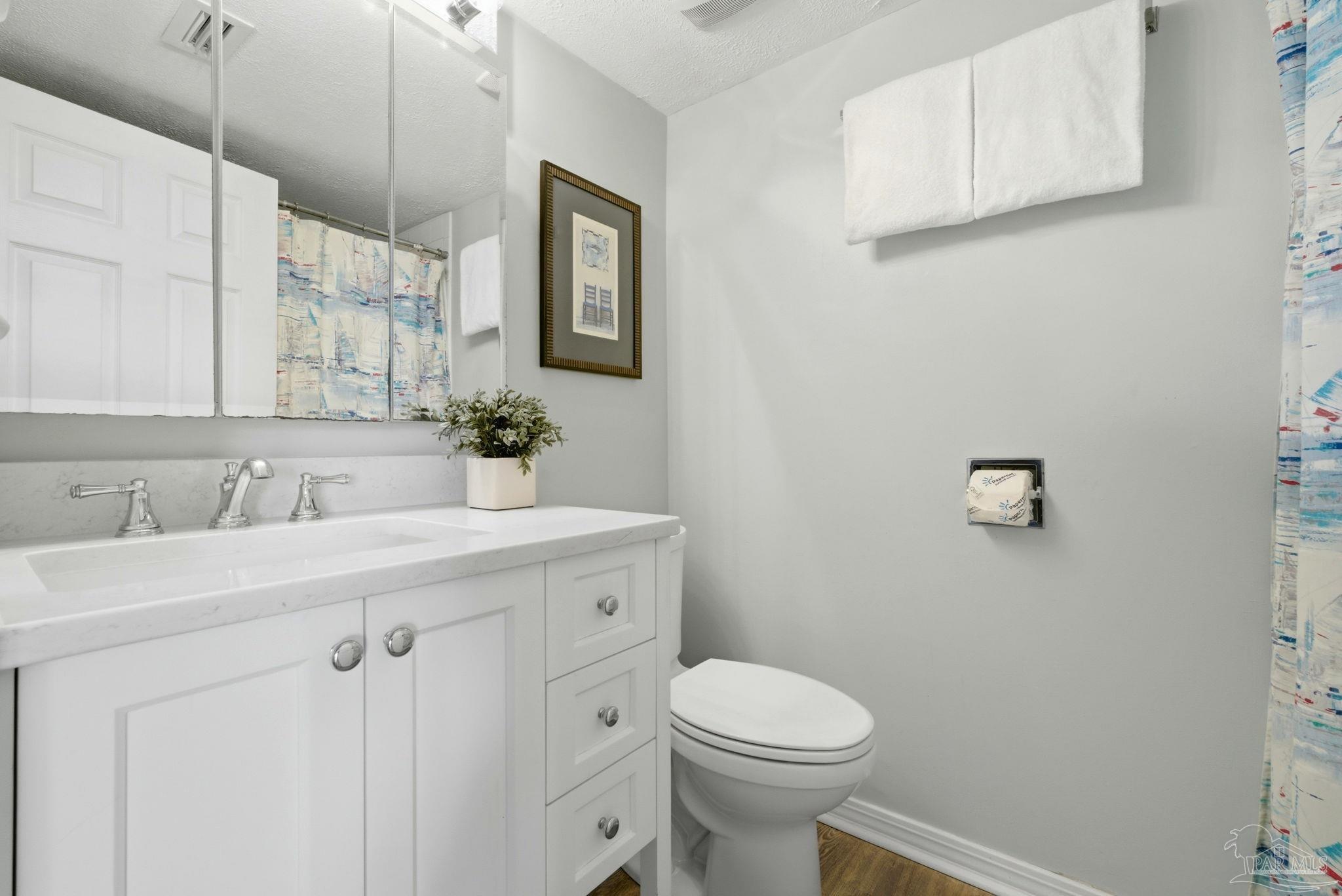 14623 Perdido Key Drive, Unit W201 Perdido Key, FL 32507 - Photo 22 of 57 a bathroom with a sink a toilet and mirror